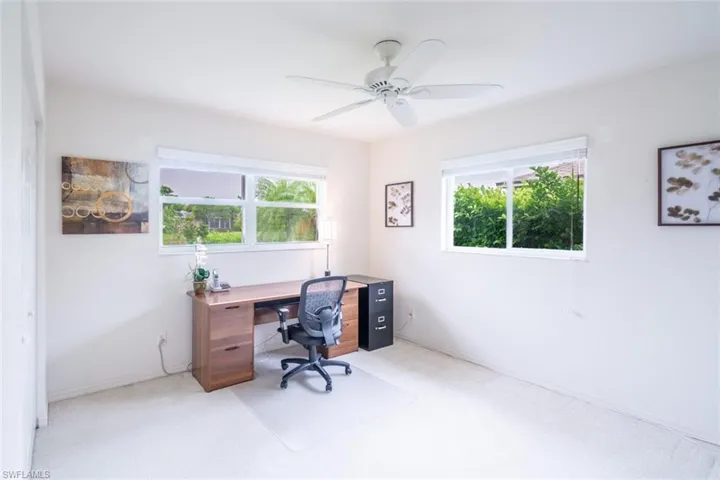 Office area featuring carpet flooring, a wealth of natural light, and ceiling fan