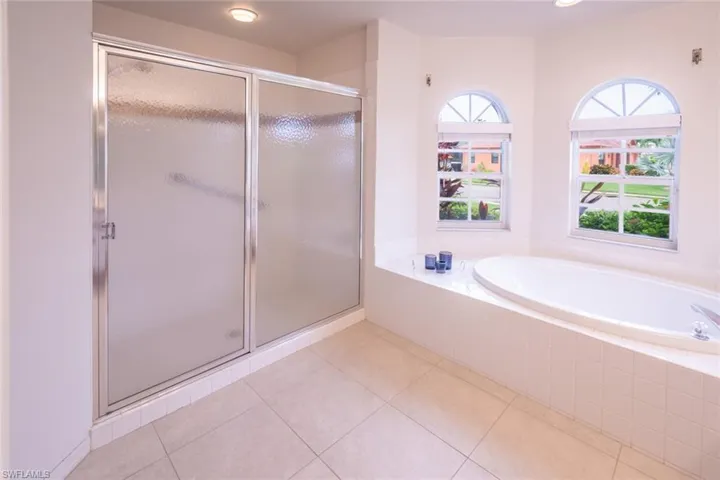 Bathroom with tile patterned floors, plus walk in shower, and plenty of natural light