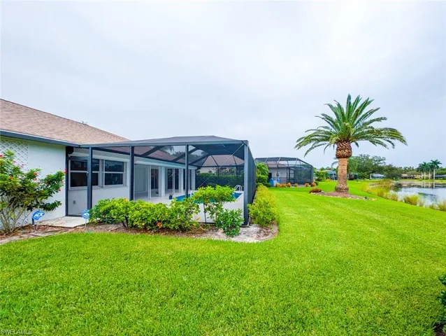 View of yard with glass enclosure