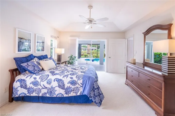 Bedroom with access to exterior, carpet, and ceiling fan