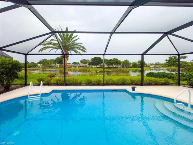 View of swimming pool featuring a water view and a lanai