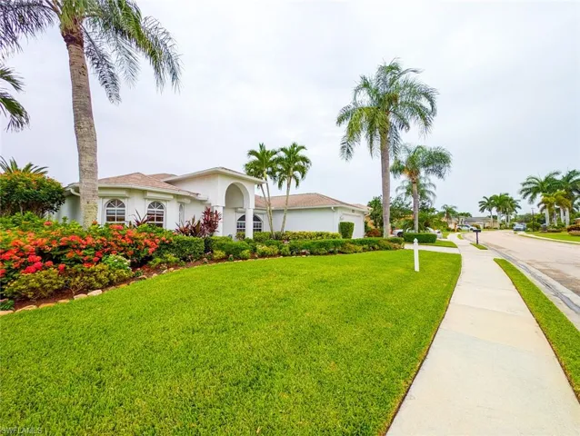 Mediterranean / spanish house with a front lawn