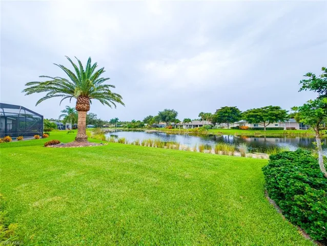 View of yard featuring a water view and a lanai