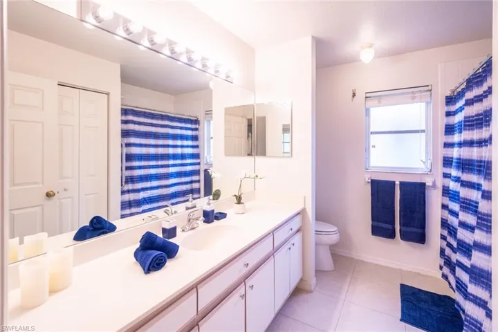 Bathroom featuring tile patterned floors, vanity, and toilet