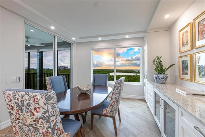 Dining room with picture window & 2 wine fridges