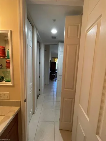 Hall with light tile flooring