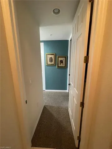 Corridor to Master Bedroom with carpet flooring
