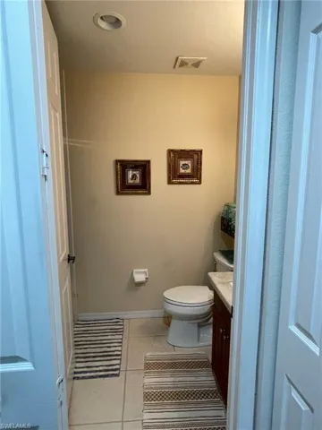 Bathroom featuring tile floors, toilet, and vanity