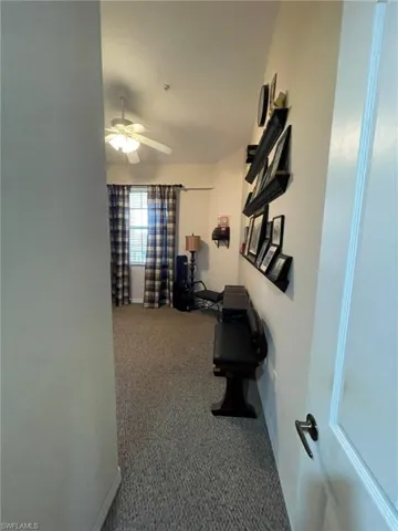 Entrance to second bedroom with carpet floors