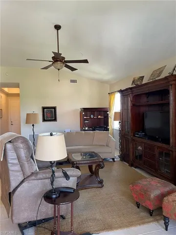 Tiled living room featuring ceiling fan