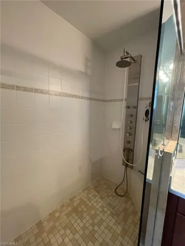 Master bathroom featuring tiled shower  and updated shower fixture