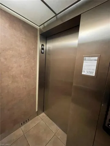 Details featuring tile flooring and elevator