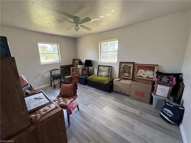 Office space with ceiling fan and light wood-type flooring
