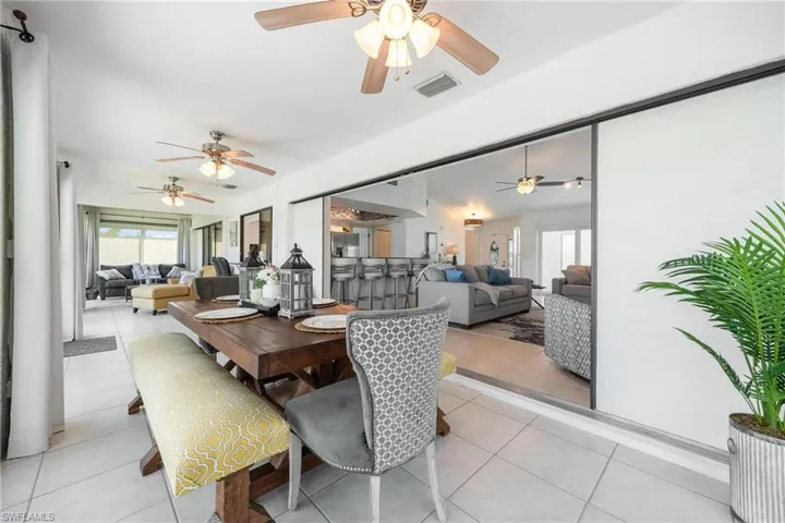 Tiled dining space featuring ceiling fan