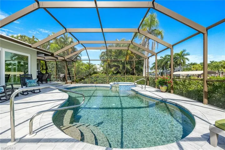 View of swimming pool featuring a patio and a lanai