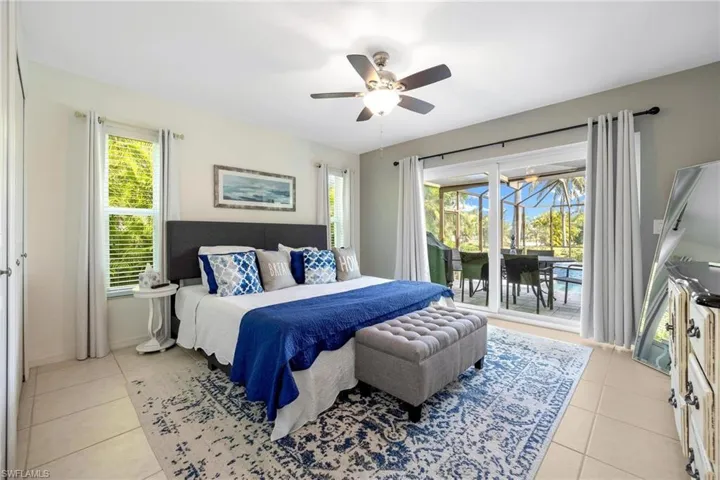 Bedroom featuring ceiling fan, access to exterior, and light tile patterned floors