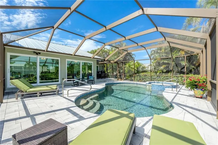 View of pool featuring a lanai, an in ground hot tub, and a patio
