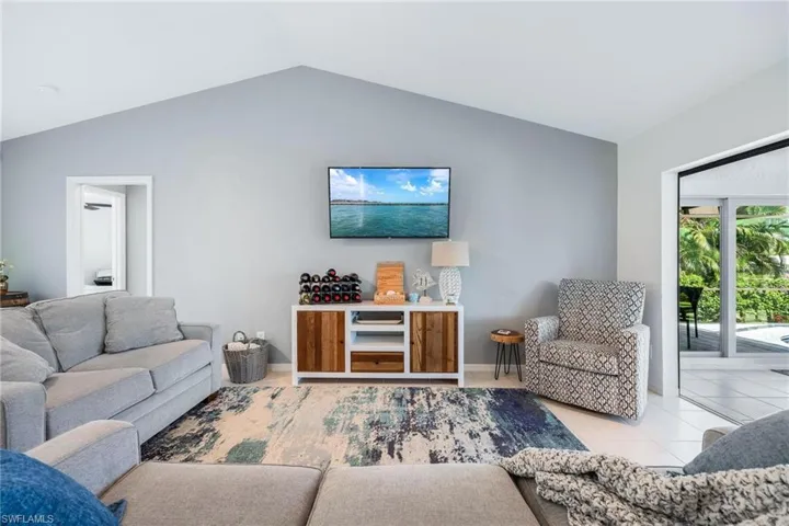 Tiled living room with lofted ceiling