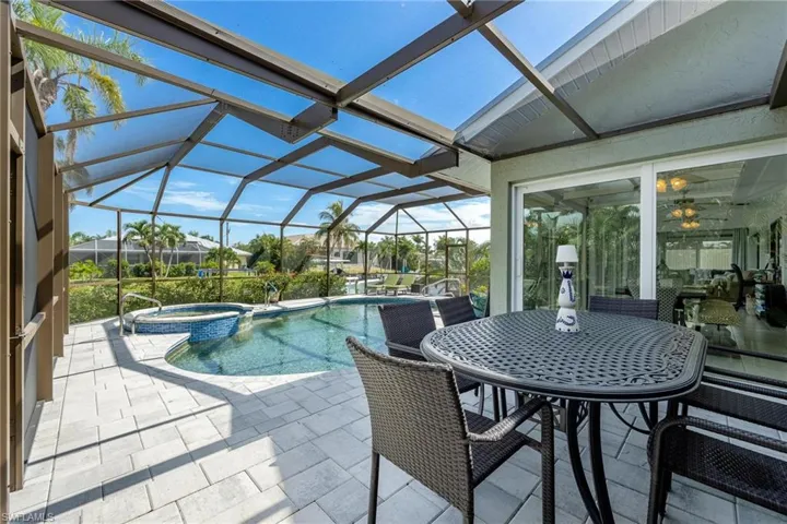 View of pool featuring a lanai, an in ground hot tub, and a patio