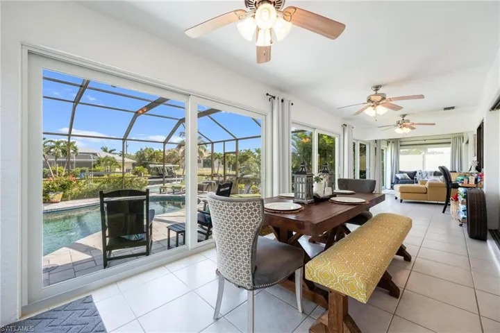 Dining space featuring ceiling fan and light tile patterned floors