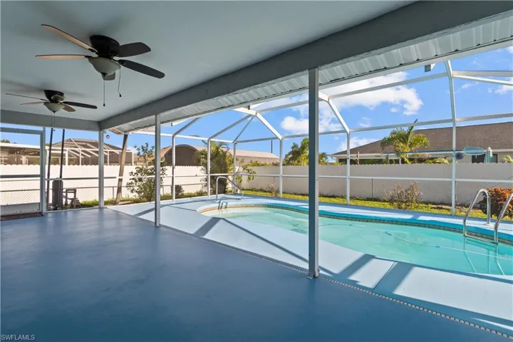 View of pool featuring ceiling fan, a patio, and a lanai