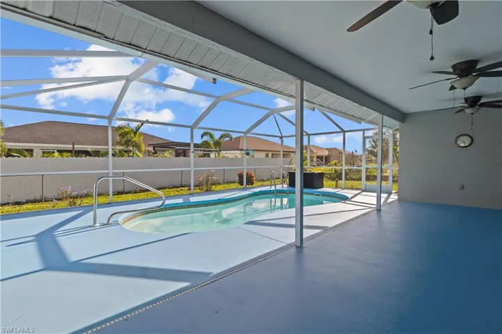 View of pool with ceiling fan, a patio area, and a lanai