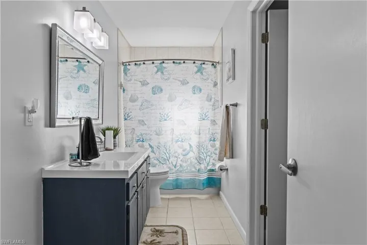 Bathroom with tile patterned floors, toilet, and vanity
