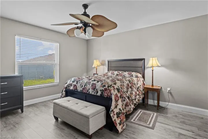 Bedroom with light hardwood / wood-style floors and ceiling fan