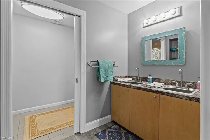 Bathroom featuring double vanity and tile patterned floors