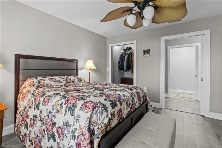 Bedroom with ceiling fan, light hardwood / wood-style flooring, and a closet