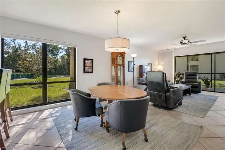 Tiled dining area featuring ceiling fan and a healthy amount of sunlight