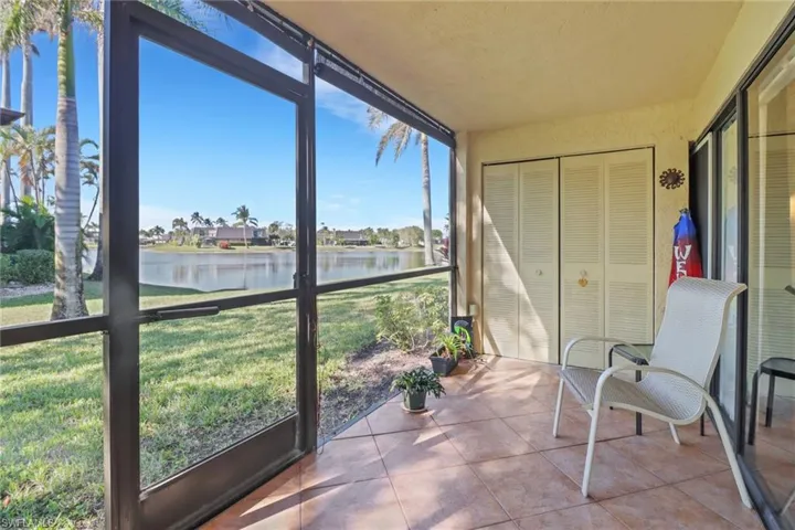 Screened in lanai featuring a water view