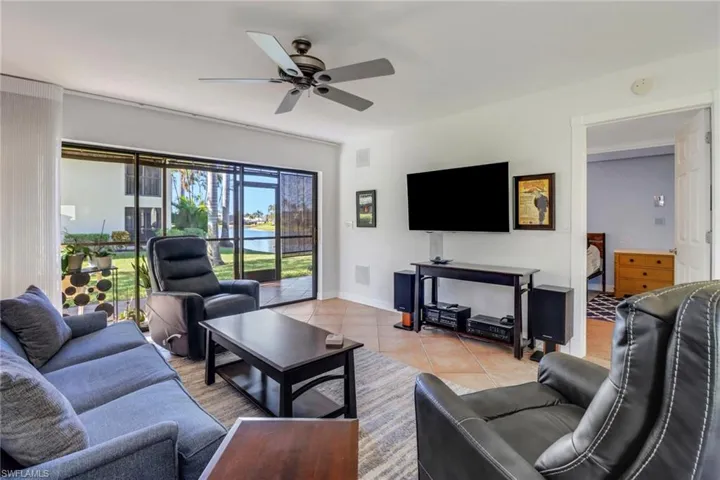 Tiled living room featuring ceiling fan
