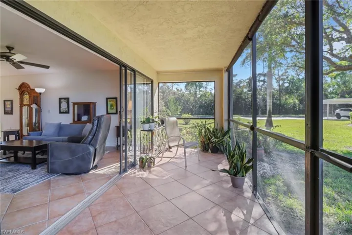 Main living area with sliders opening up to screened in lanai welcoming the refreshing lake breezes