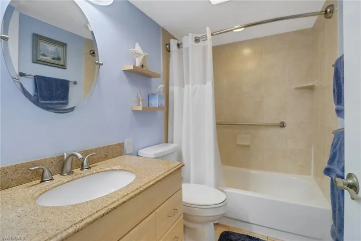 Full bathroom featuring tile patterned floors, vanity, toilet, and shower / bath combo