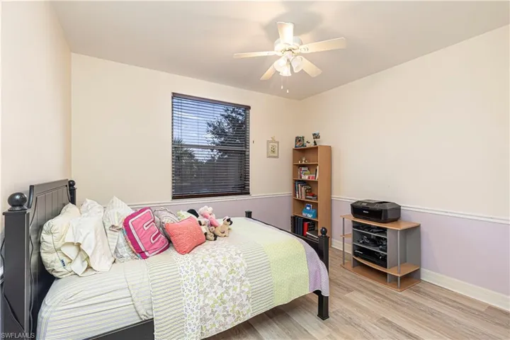 Bedroom with ceiling fan and light hardwood / wood-style flooring