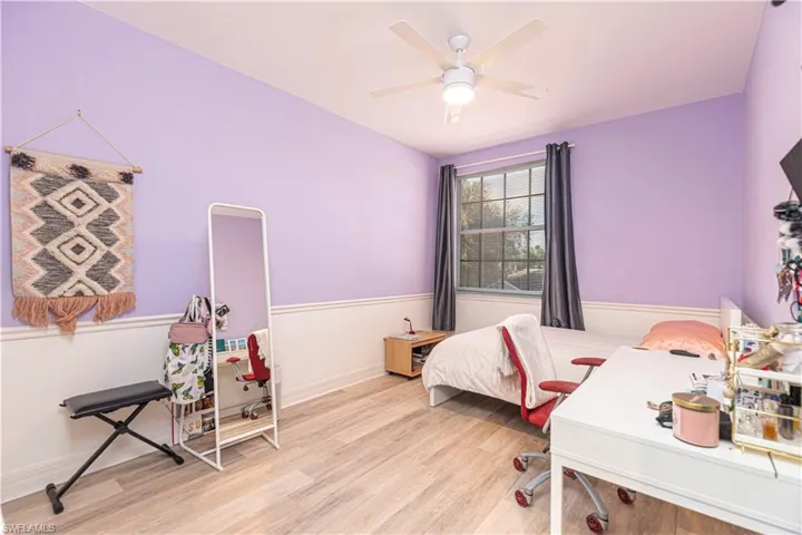 Bedroom with ceiling fan and light hardwood / wood-style floors