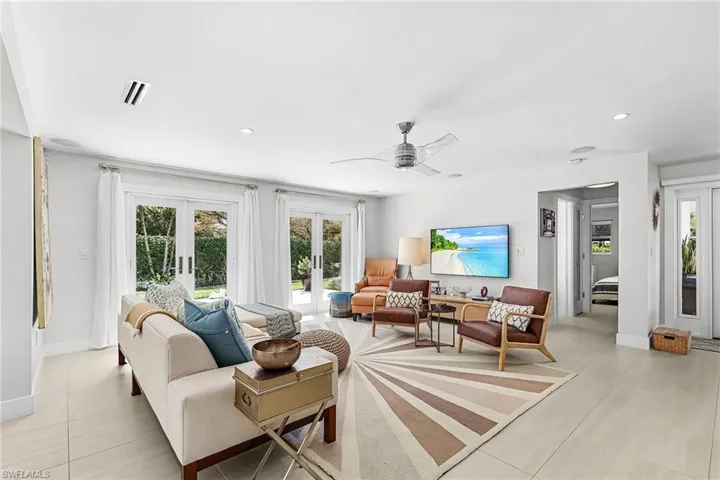 Living room featuring french doors, a ceiling fan, and recessed lighting