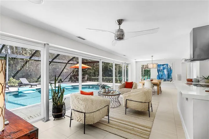 Sunroom / solarium with an outdoor lounge area, a ceiling fan, a swimming pool, and a patio