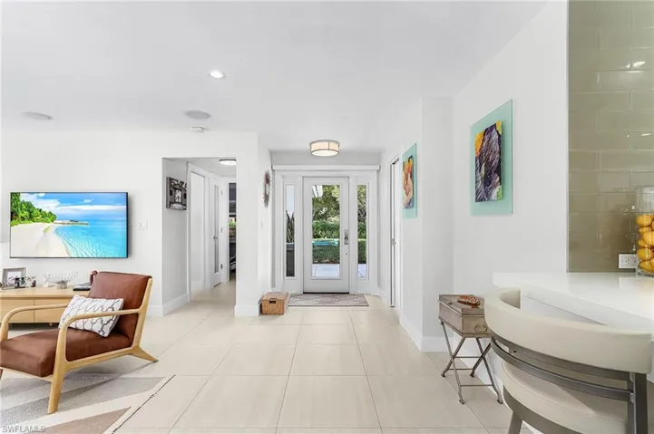 Foyer with baseboards and light tile patterned flooring