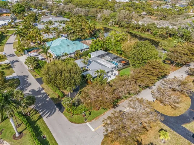 Aerial view of residential area featuring a tree filled landscape