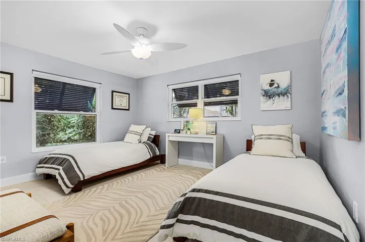 Bedroom featuring multiple windows and ceiling fan