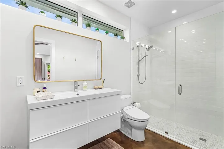Full bath featuring vanity, a stall shower, and recessed lighting