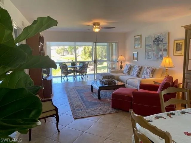 Living room featuring tile patterned flooring and ceiling fan
