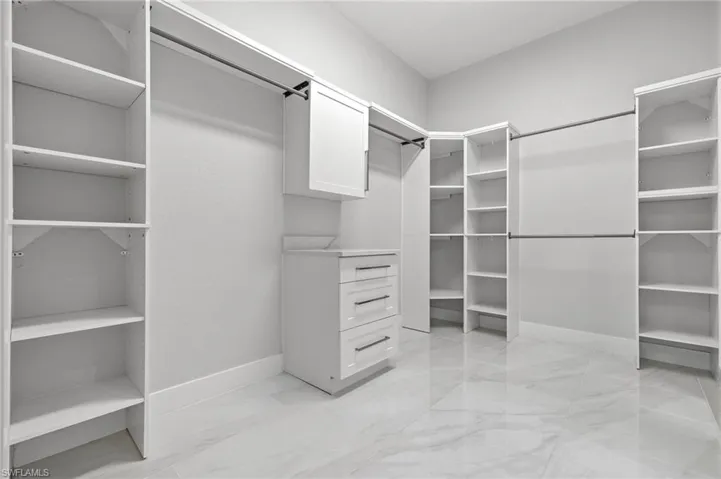 Owner's Closet with entry to laundry room.
