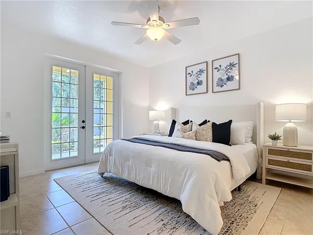 Bedroom with french doors, access to outside, ceiling fan, and light tile patterned flooring