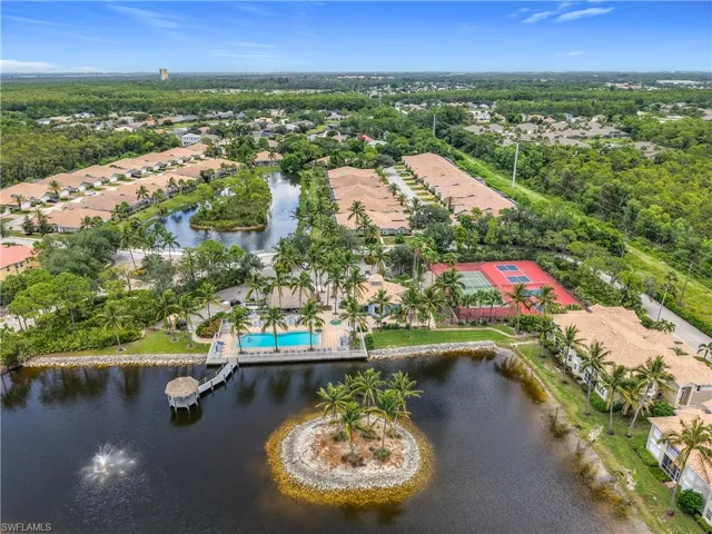 Aerial view of residential area featuring a large body of water and a pool