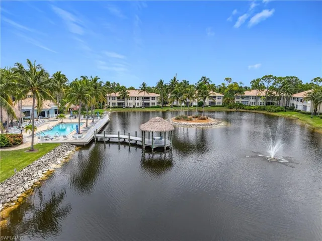 Water view with a boat dock and nearby suburban area
