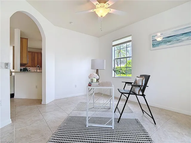 Sitting room featuring arched walkways and ceiling fan