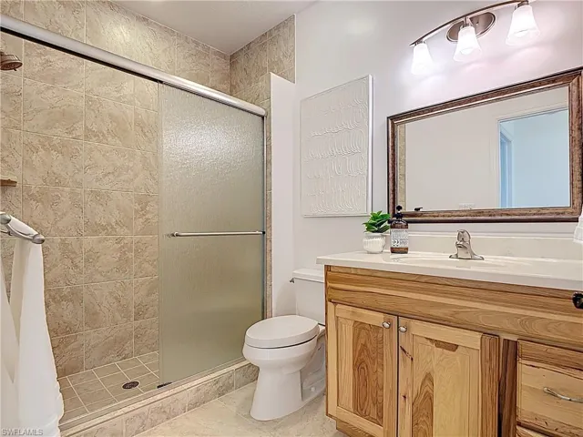 Full bath featuring a shower stall and vanity
